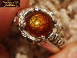 Small Picture 2 DCJ003 7 x 7 mm gemstone set in sterling silver ring with a bright fire being displayed